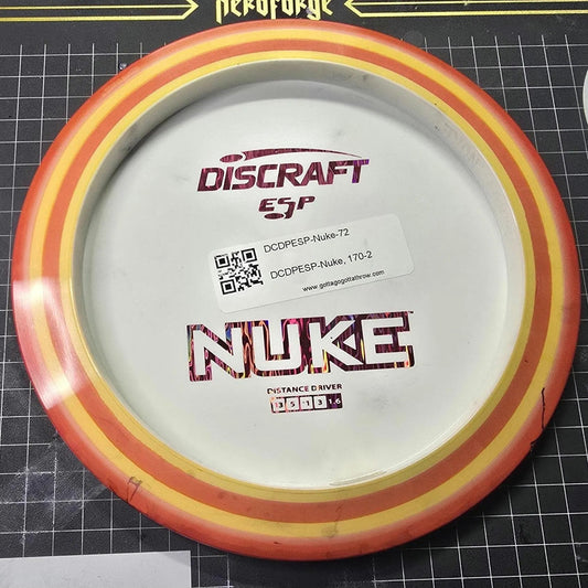 Discraft Disc Golf disc on a cutting mat with various logos in the background