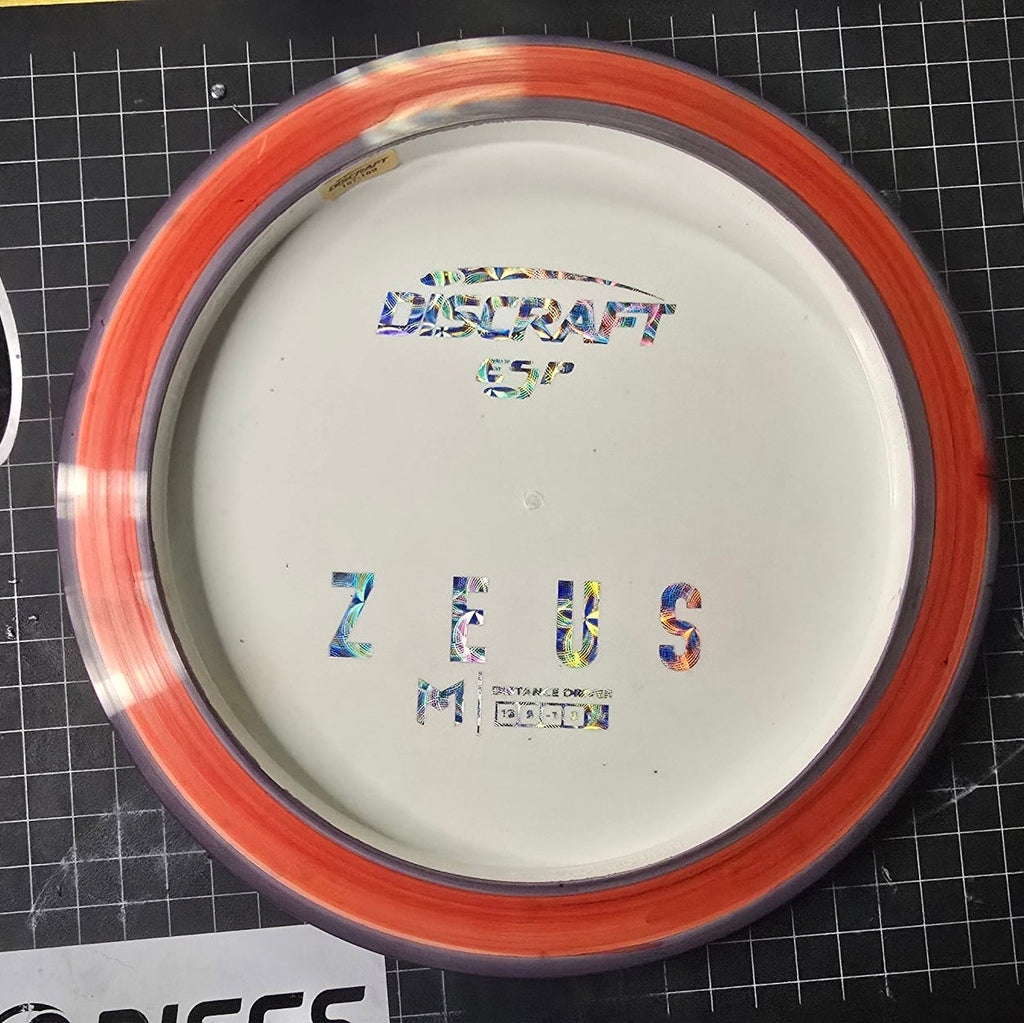 Discraft Zebrs disc golf disc on a cutting mat with branding visible