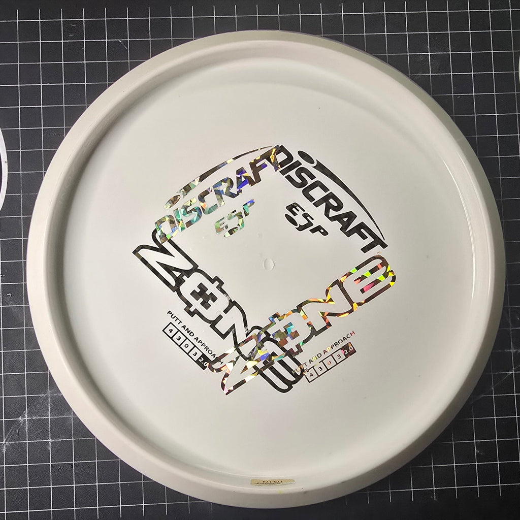 Disc golf disc with branding on a grid background